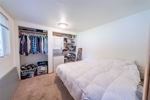 carpeted bedroom featuring a closet and stacked washer and dryer