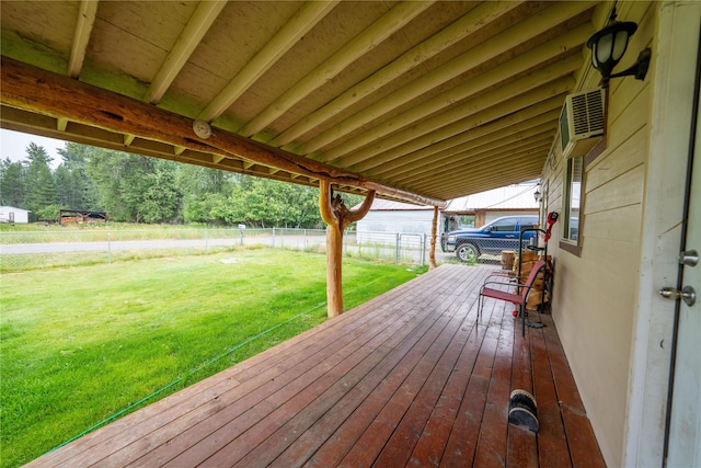 wooden deck featuring an AC wall unit, a lawn, and fence private yard