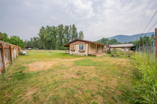 view of yard with a fenced backyard and a mountain view