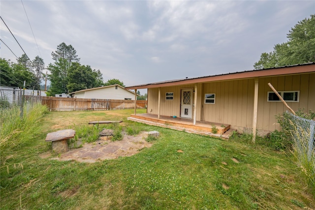 back of property featuring a lawn and a fenced backyard