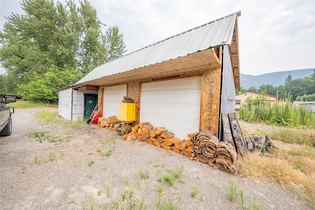 detached garage featuring a mountain view