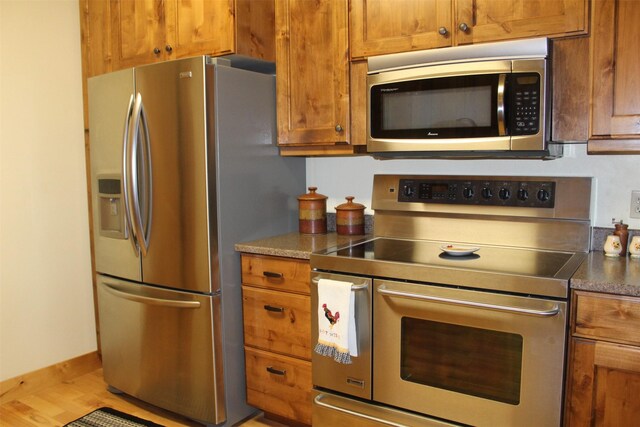 kitchen featuring appliances with stainless steel finishes and light wood-type flooring