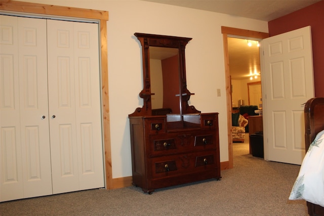 bedroom with a closet and light colored carpet