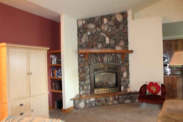 carpeted living room with vaulted ceiling and a fireplace