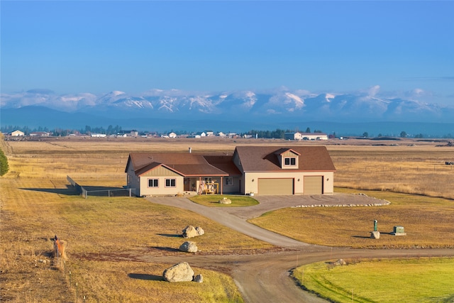 881 Lone Coyote Trl, Kalispell, MT 59901 - view of front of home with a rural view, driveway, a garage, and fence