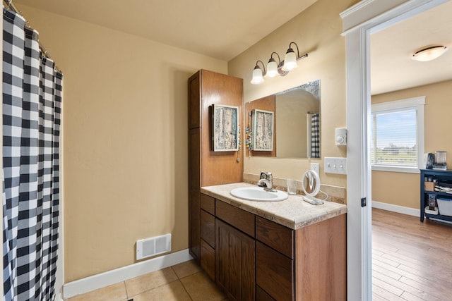 881 Lone Coyote Trl, Kalispell, MT 59901 - full bath with tile patterned floors, visible vents, a shower with curtain, baseboards, and vanity