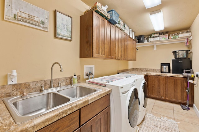 881 Lone Coyote Trl, Kalispell, MT 59901 - laundry area featuring washer and clothes dryer, cabinet space, and light tile patterned floors