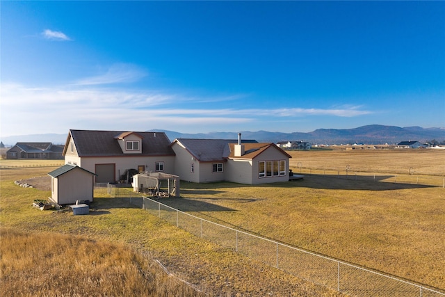 881 Lone Coyote Trl, Kalispell, MT 59901 - back of property featuring a mountain view and a storage unit
