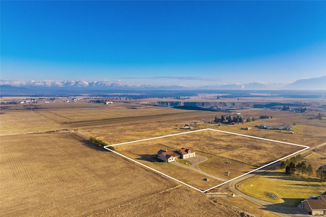881 Lone Coyote Trl, Kalispell, MT 59901 - aerial view of sparsely populated area featuring property boundaries highlighted and a mountainous background
