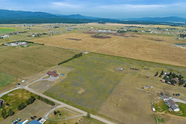 881 Lone Coyote Trl, Kalispell, MT 59901 - aerial view of property and surrounding area with a mountain backdrop and rural landscape