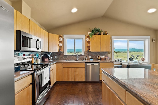 881 Lone Coyote Trl, Kalispell, MT 59901 - kitchen featuring appliances with stainless steel finishes, open shelves, light stone counters, lofted ceiling, and tasteful backsplash