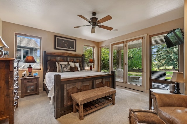 bedroom featuring light carpet, ceiling fan, and access to exterior