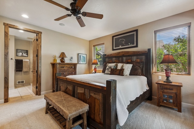 carpeted bedroom with ceiling fan and connected bathroom