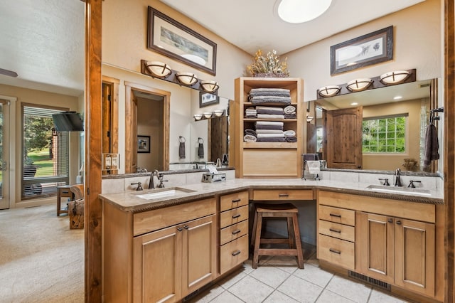 bathroom featuring dual vanity, tile patterned floors, and a wealth of natural light