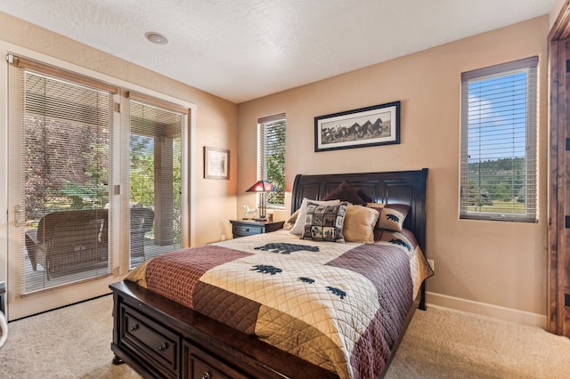 carpeted bedroom with access to outside