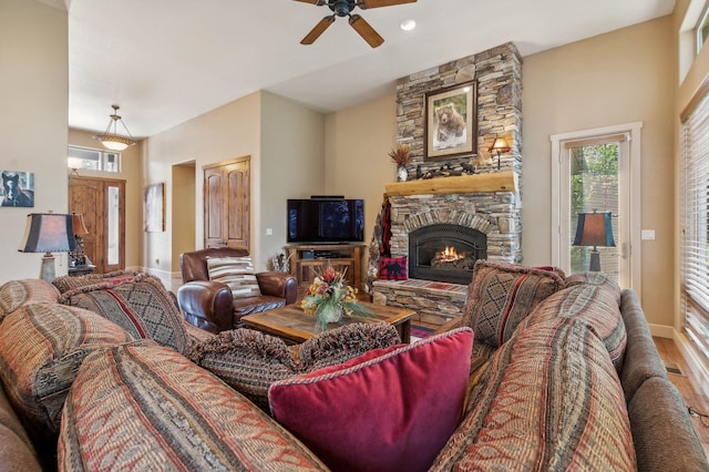 living room featuring a fireplace, hardwood / wood-style floors, and ceiling fan