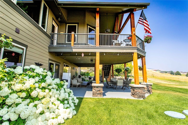 back of house with a patio and a yard