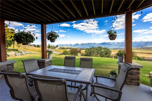 view of patio featuring outdoor dining area and a mountain view