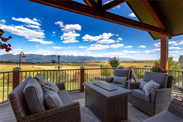 deck featuring a mountain view and a rural view