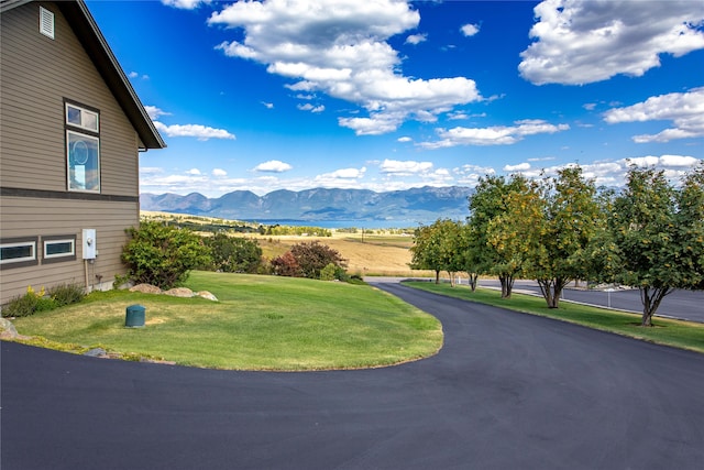 exterior space featuring a mountain view and a yard