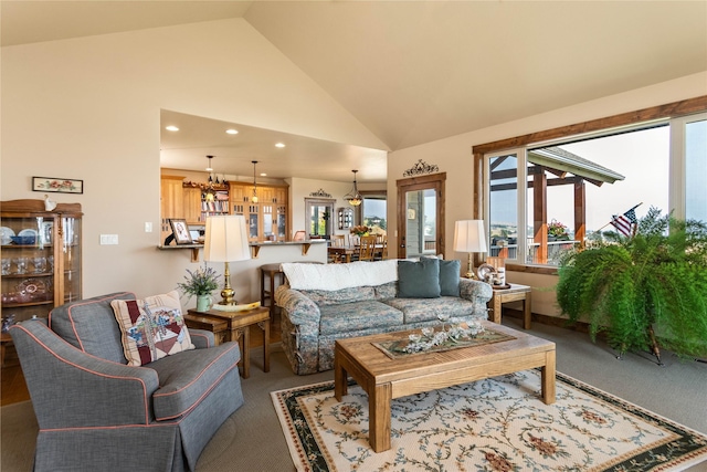 carpeted living area with recessed lighting and vaulted ceiling