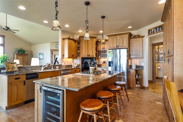 kitchen featuring ceiling fan, pendant lighting, a breakfast bar area, wine cooler, and appliances with stainless steel finishes