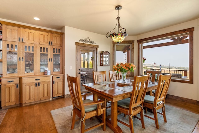 dining area featuring light wood finished floors and recessed lighting