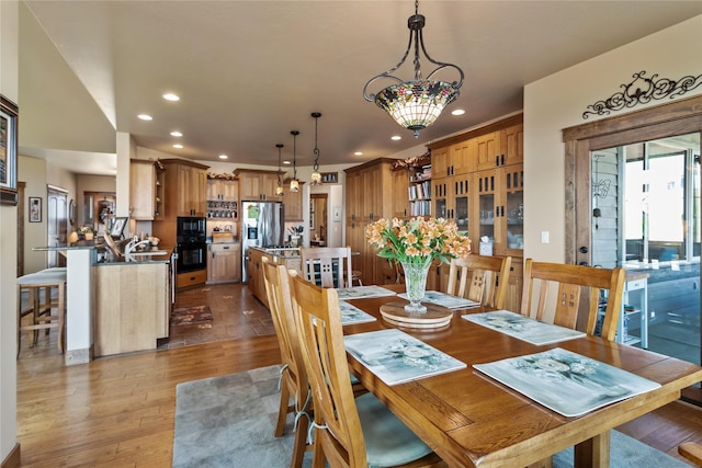 dining area with recessed lighting and dark wood finished floors