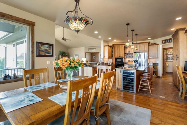 dining area featuring wine cooler, wood finished floors, a wealth of natural light, and ceiling fan