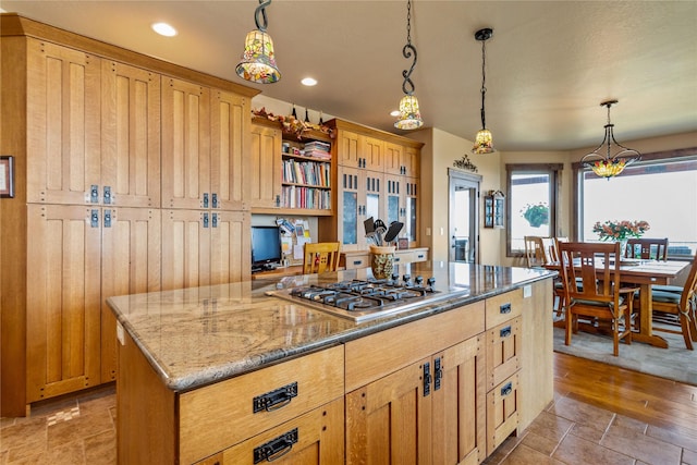 kitchen with a center island, recessed lighting, pendant lighting, light stone counters, and open shelves