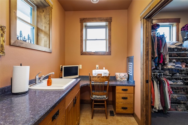 bathroom featuring vanity, tile patterned flooring, and a walk in closet