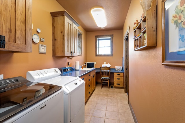 laundry room with a sink, baseboards, separate washer and dryer, cabinet space, and light tile patterned floors