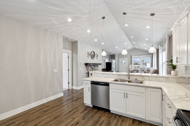 kitchen with open floor plan, a peninsula, stainless steel dishwasher, white cabinetry, and a sink