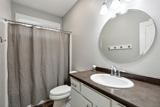 full bath featuring vanity and toilet