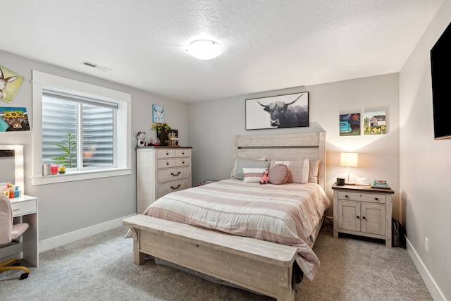 bedroom with baseboards, visible vents, a textured ceiling, and carpet flooring