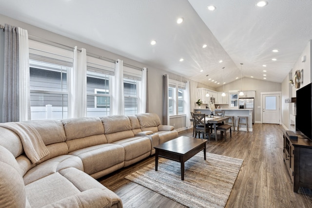 living room with lofted ceiling, light wood-type flooring, baseboards, and recessed lighting