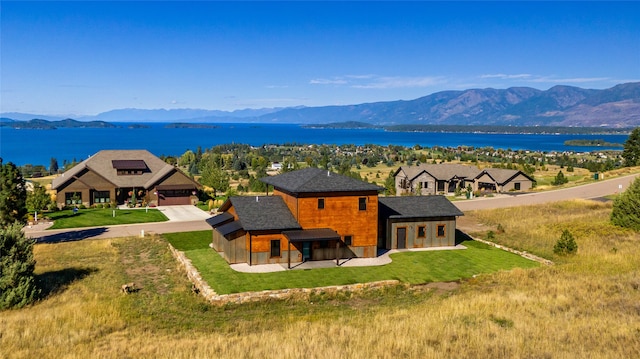 exterior space with a water and mountain view