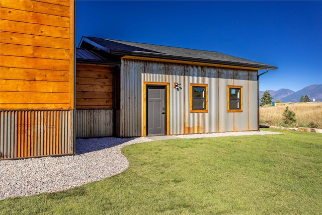 exterior space featuring a mountain view and a yard