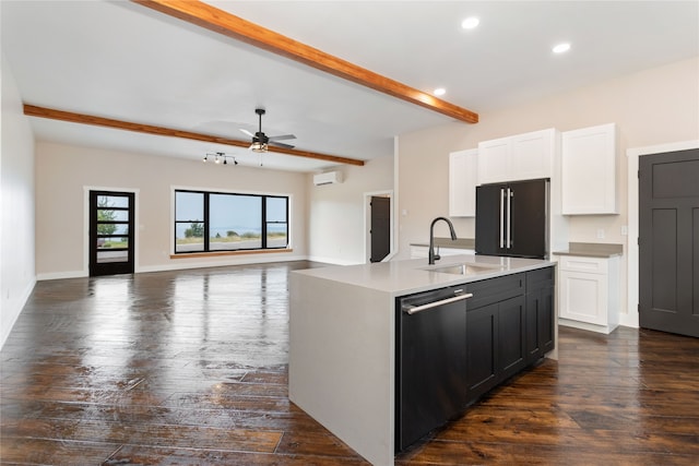 kitchen featuring appliances with stainless steel finishes, white cabinetry, ceiling fan, a center island with sink, and dark hardwood / wood-style floors