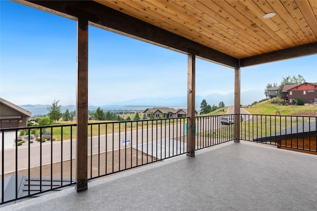 view of patio featuring a mountain view and a balcony