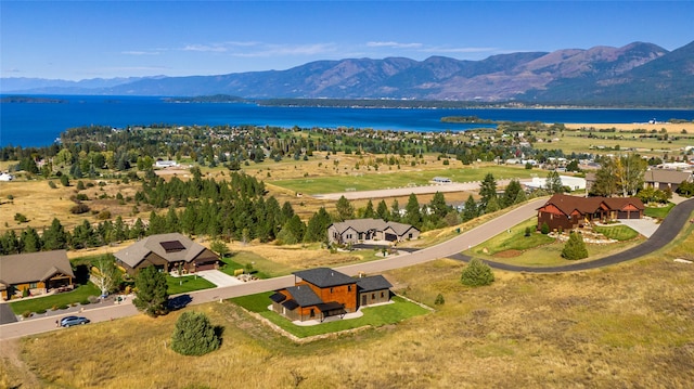 aerial view featuring a water and mountain view