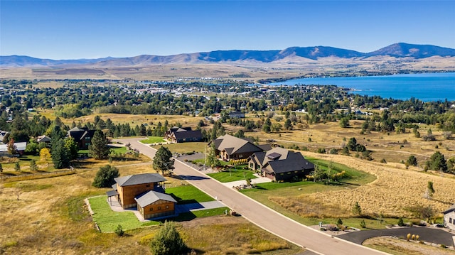 aerial view featuring a water and mountain view