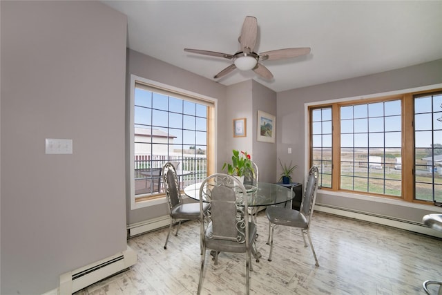 dining room with a baseboard radiator, a wealth of natural light, and wood finished floors