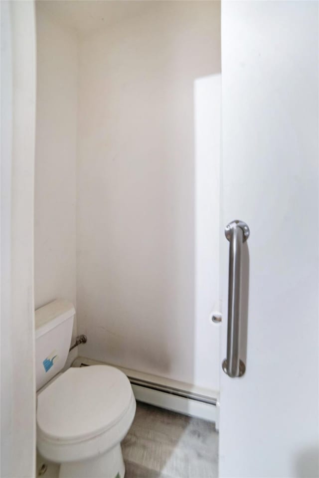 bathroom with toilet and baseboard heating