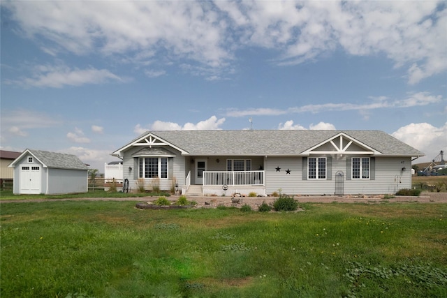 view of front of home with a porch, an outdoor structure, a front lawn, and a storage unit