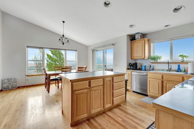 kitchen featuring light wood-type flooring, dishwasher, a kitchen island, decorative light fixtures, and sink