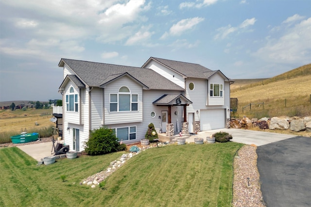 view of front of property with a garage and a front yard