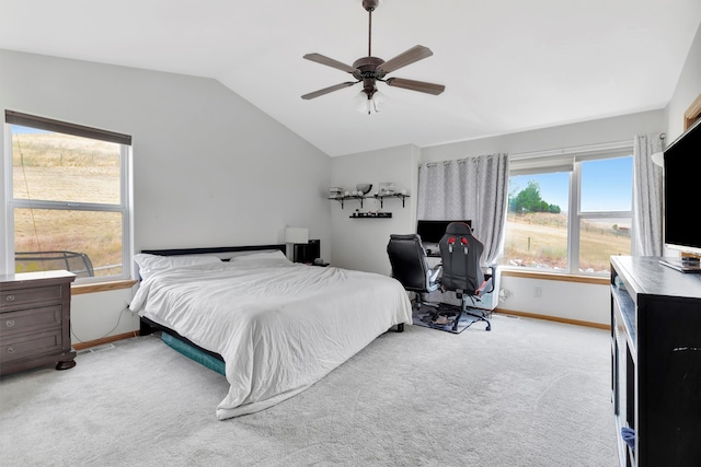 carpeted bedroom with ceiling fan and vaulted ceiling