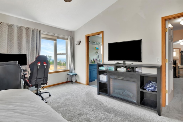 bedroom with light carpet and vaulted ceiling