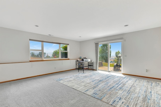 unfurnished room featuring carpet floors and plenty of natural light